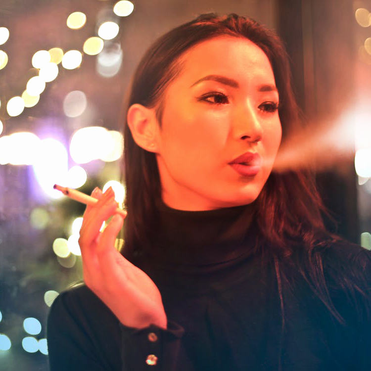 Young Asian Woman smoking a cigarette