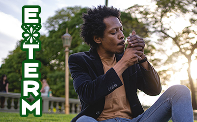 Black man smoking marijuana in a park with E-Term logo