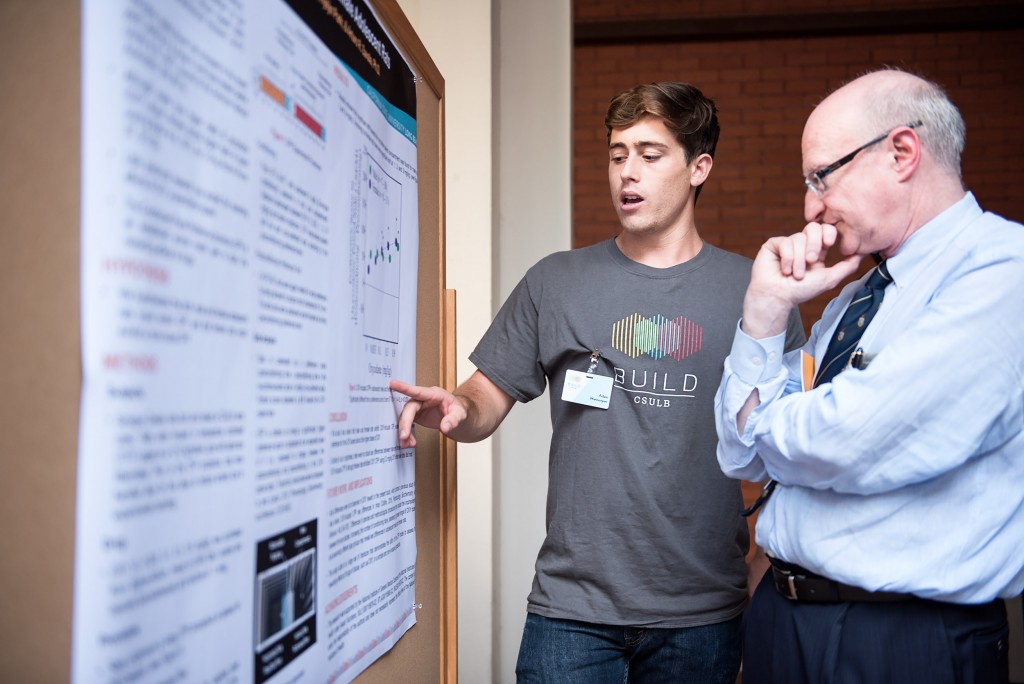alt="BUILD students showcase their research during a poster session exhibit."