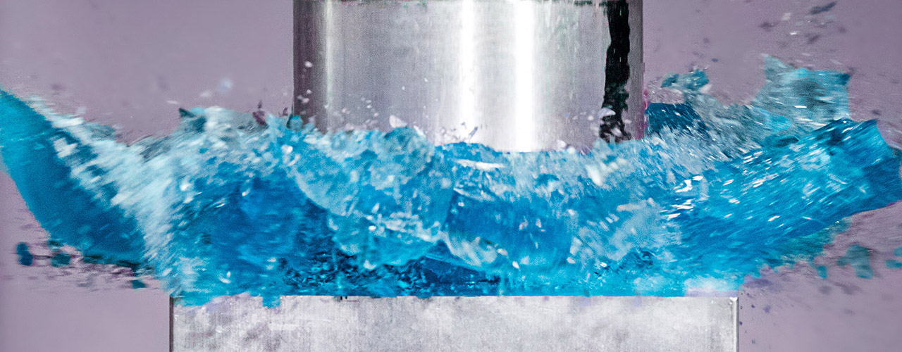 Close up of machine crushing blue ice.