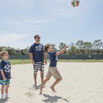 Boy with fake mustache playing volleyball