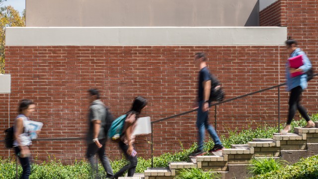 Students go up and down the stairs on campus.