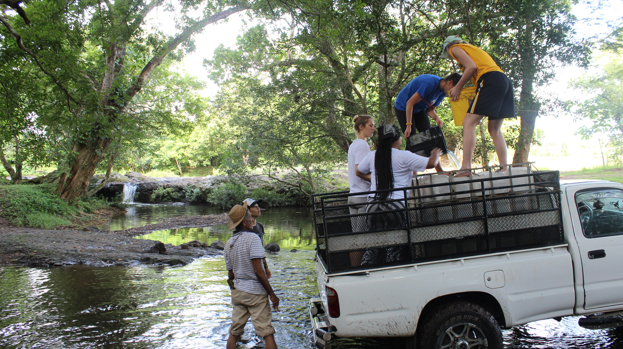 Long Beach State students and sponsors gather water for cement.