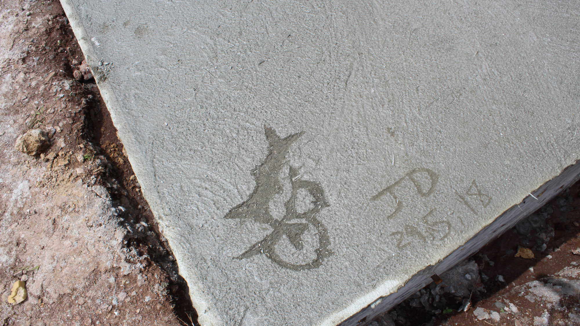 LB etched in concrete