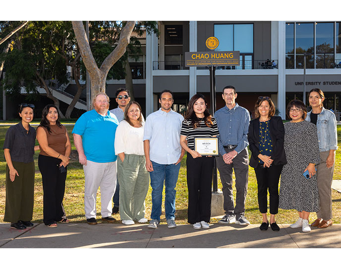 Chao Huang joined by President Jane Close Conoley, Chris Swarat, Dean of CPaCE, Alysa Turkowitz, Associate Dean of CPaCE, and numerous campus colleagues on Friendship Walk