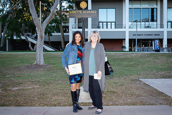 President Conloey with Lisette at the ETOM signpost on Friendship Walk