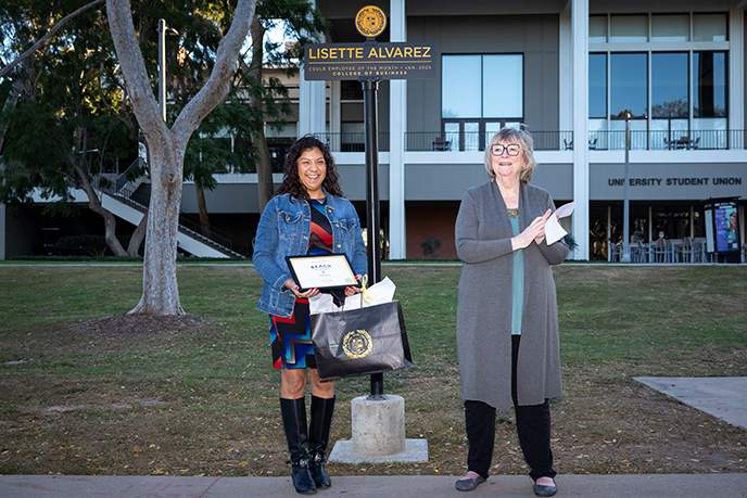 President Conloey with Lisette at the ETOM signpost on Friendship Walk