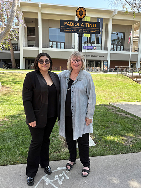 Fabiola Tinti and President Conoley at the ETOM signpost on Friendship Walk