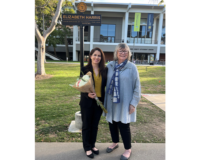 Liz Harris and President Conoley at the ETOM signpost on Friendship Walk